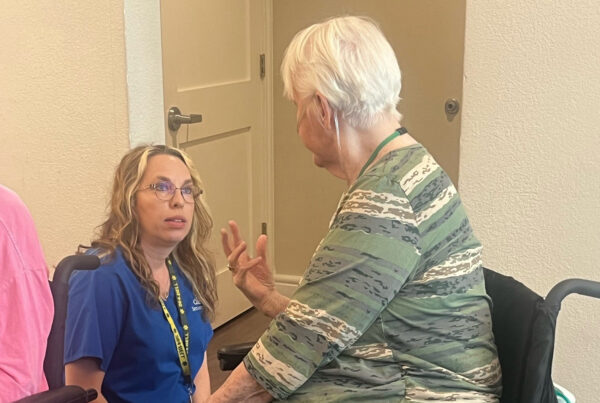 Jolie Kitzke talking to a resident